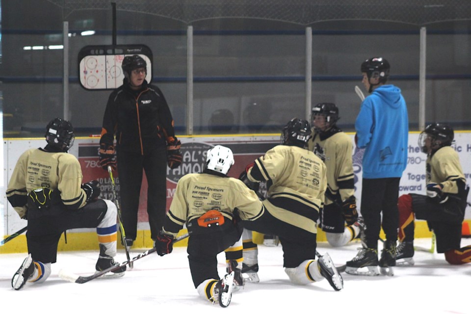 Instructor Chris Driessen speaks with a group of the older players on Aug. 27.