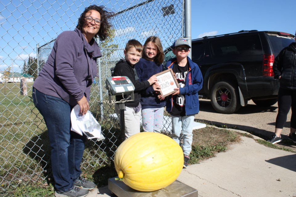 The Greater Athabasca Community Foundation presented its second annual Pumpkin Weigh-in at Mill View Park in Boyle Sept. 24, handing out recognition for the biggest gourd in the land. This year, that recognition went to the Sheen kids (L-R), Wyatt, Olivia and Lloyd who accepted congrats from GACF’s Lindsay Stanton for their 71.6 pound pumpkin, which edged out their closest competition by less than a pound.