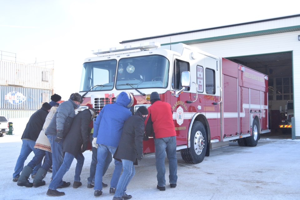 Push-in ceremony:  Municipal elected officials join the Fire Service Committee in symbolically pushing Engine 37 into the hall.