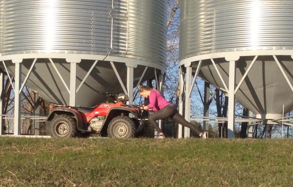 The key to explosive starts is pushing weight over a short distance which Melissa Lotholz demonstrates during her home workout routine by pushing a quad.