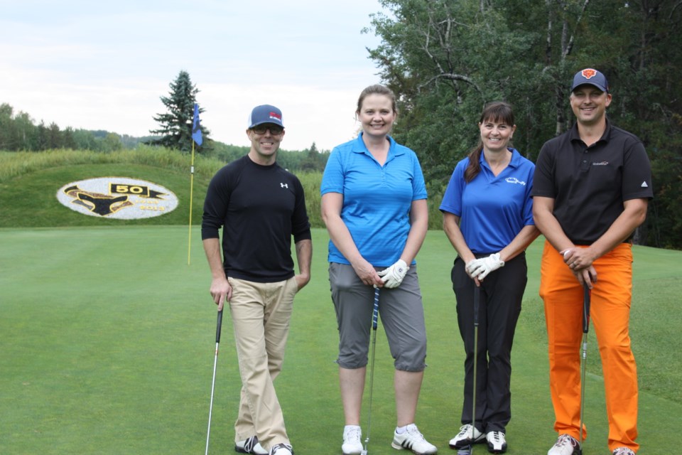 An overcast and drizzly morning gave way to a sunny afternoon as the Road to Hope Golf Classic returned to the Athabasca Golf & Country Club Sept. 9 with more than 100 golfers from around the region hitting the links in support of the organization whose volunteer drivers transport cancer patients to and from their treatments in the city. The Athabasca County foursome of Sheldon Schoepp, Sara Graling, Lorelei Sztym and Curtis Creaser pause for a photo after sinking their putts. 