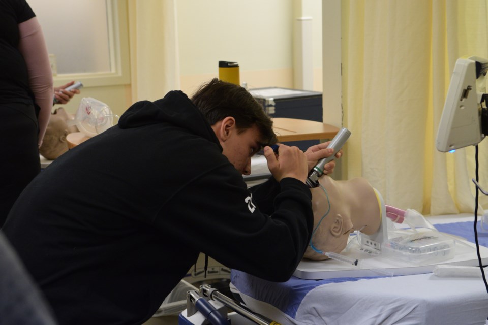BCHS Grade 10 student Gabriel Marinutti intubates a patient during RhPAP skills day at the Barrhead Healthcare Centre.