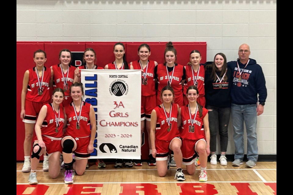 The T-Birds show off their championship banner following their 67-30 victory over Morinville Central High School (MCHS) in the final of the North Central 3A Zone Championships, which were hosted March 8-9 at R.F. Staples.