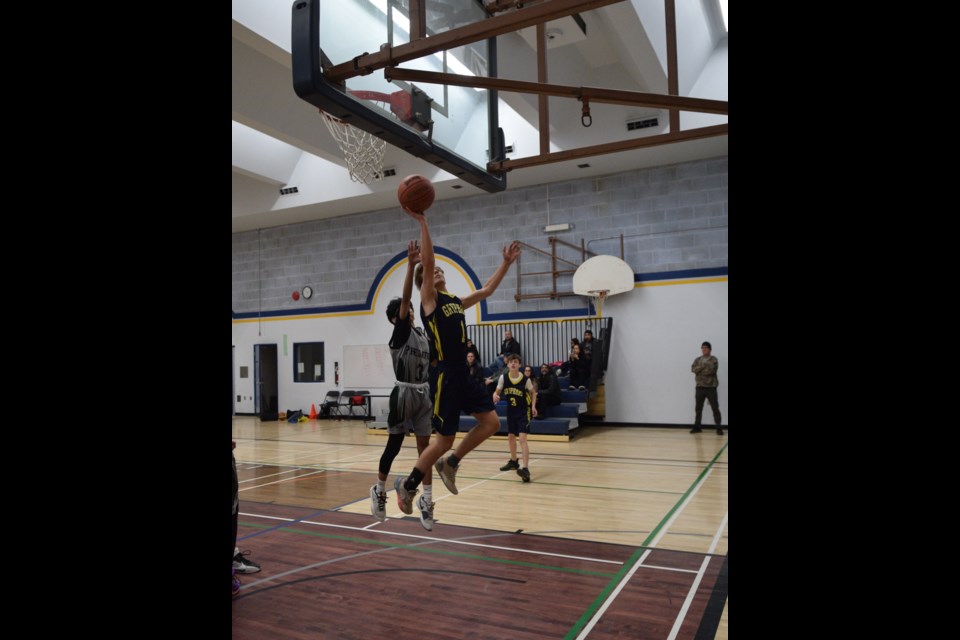 Barrhead Gryphon Ryder Sabiston with a jumping one-handed scoring attempt.