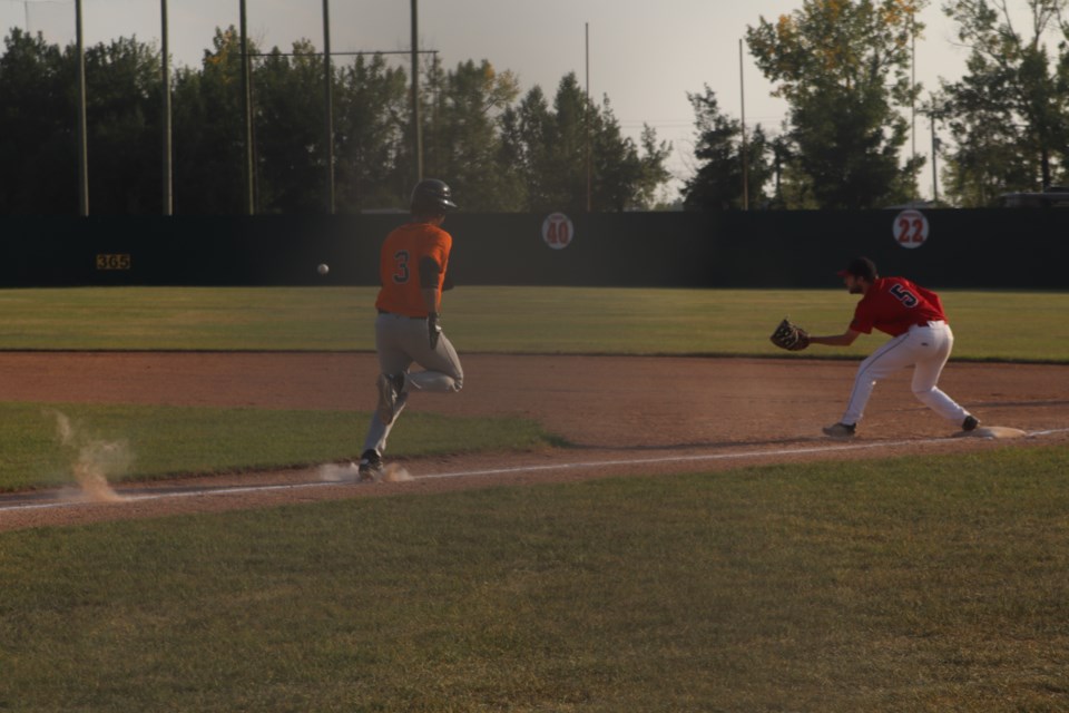 Lee Worobec (3) runs to first base for the Barrhead Orioles against the Westlock Red Lions as Carter Hagel watches the ball.