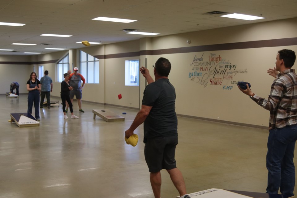 Participants compete in the cornhole tournament at the Westlock Rotary Club fundraiser for the Eastglen accessible park.