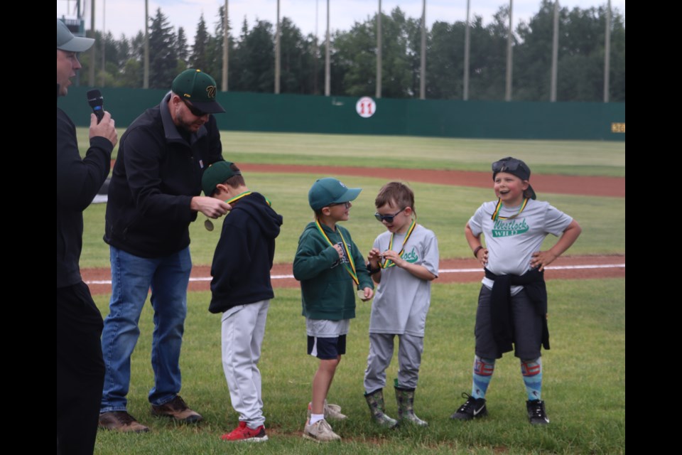 Rally Cap Team Andrusiak at the Westlock Wild minor ball awards ceremony at Keller Field on June 19. From L-R: Kelly Hess (handing out medal), Tucker Olson, Cohen Andrusiak, Colt Davie and Waylon Fandrick.