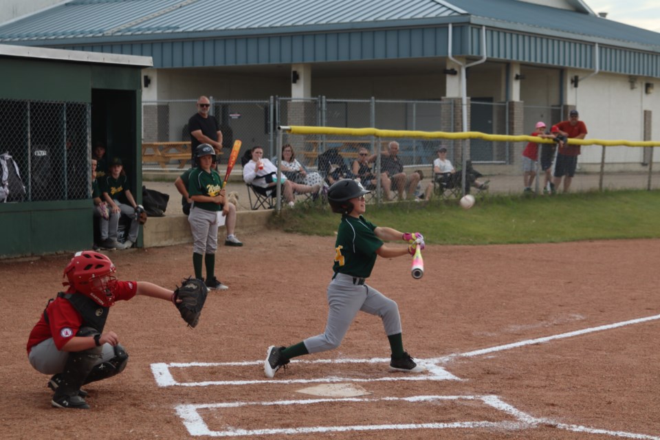 Ryker Beamish scores a hit for the Westlock Wild U11 baseball team against the Edmonton Angels on July 8.