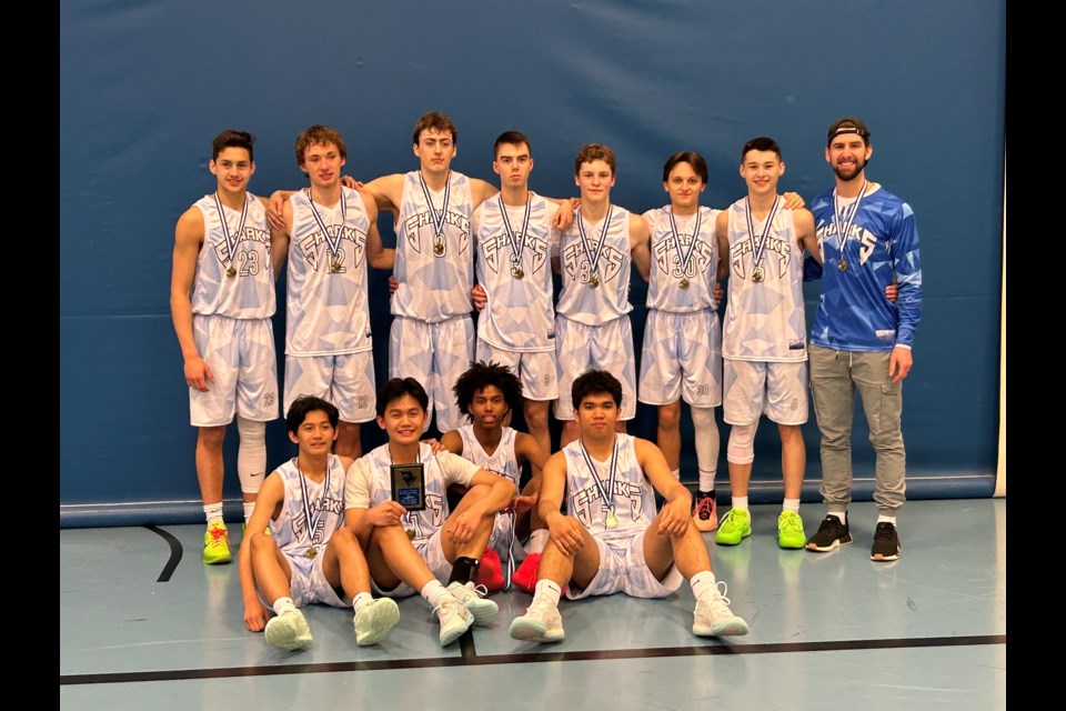 The St. Mary Sharks senior boys' basketball team gather together after winning the 1A North Central ranking tournament in Westlock on Feb. 16-17.