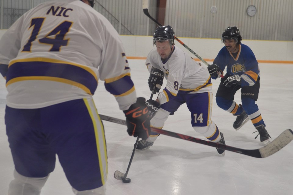 Nic Bourgeois' brother Steve with  teammate Scott Littke in front of him and Jona Cisse of the Chiefs, comprised mostly of Barrhead players in the background.