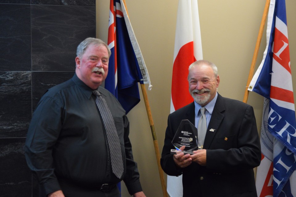 Steven Bablitz accepts the ABMunis Distinguished Service Award on behalf of his father from Town of Barrhead mayor Dave McKenzie during a short ceremony during the Oct. 11 council meeting. 