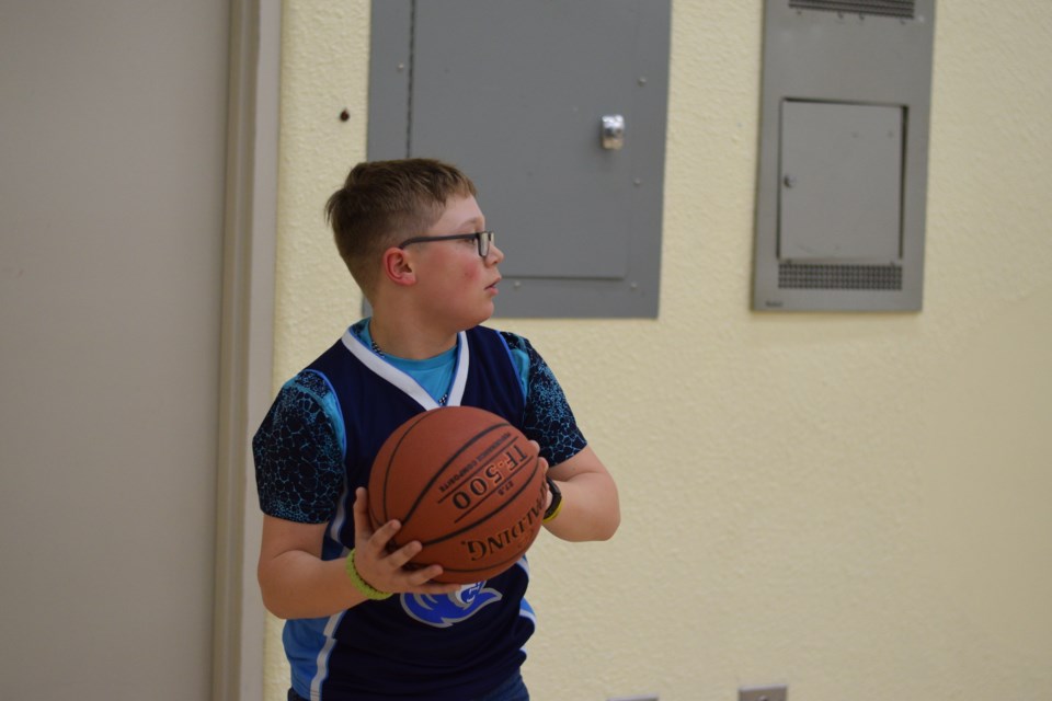 Dunstable Tanner Felske looks for a teammate to pass to put the ball back into play after it had been knocked out of bounds by one of his Barrhead opponents.