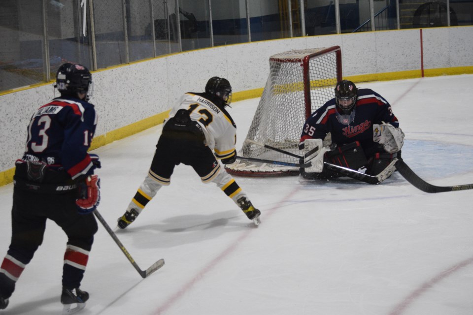 Tanner Harrison of the Barrhead Pirates tries to score from a tough angle early in the second period in a playoff game against the Wetaskiwin goaltender after winning a battle for the puck in the corner.