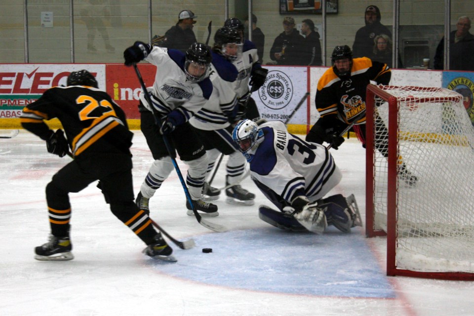 Following a scramble, U18-1 Hawks player #22 Jacob Bury managed to push the puck into the open net Sunday afternoon at the Multiplex before the Slave Lake goaltender could dive across the crease. The U18-1 team improved their record on the season to 7-2-2 with two weekend wins, and recently learned they will be hosting the Tier 2 Hockey Alberta Provincial Championships Mar. 30 – Apr. 2, which earns them a bye to the tournament. 