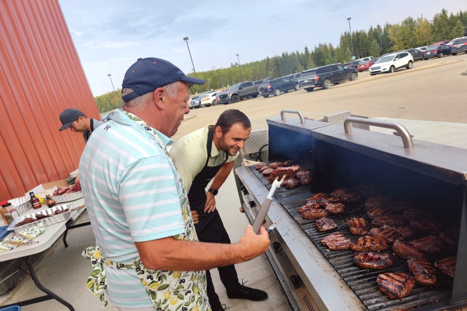 The Town of Athabasca took the time to say thank you to town staff, firefighters and local volunteers at the Multiplex Sept. 15 with a steak dinner, drinks and some recognition for long service to the community. Pictured, Coun. Jon LeMessurier keeps a careful watch on mayor Rob Balay, who kept a careful eye on the grill and enough beef to feed 120 people. 