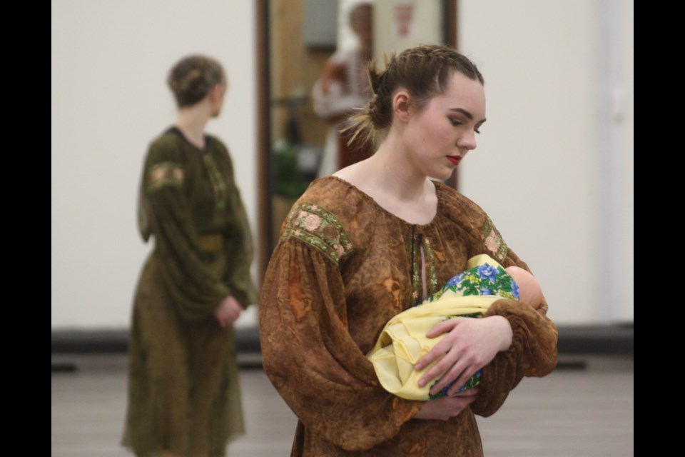 Carly Goller cradles a baby doll while performing a lyriical dance called "My Homeland" during the Westlock Vrozhay Ukrainian Dancers' year-end show on April 14 at the Clyde Curling Complex. This dance in particular was meant to be less showy and more symbolic of the horrors of war.