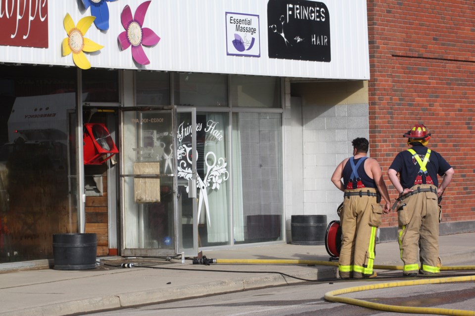 Firefighters set up fans to clear the downtown Westlock building of smoke. Although they were able to quickly douse the blaze, crews remained on scene past 10 p.m.