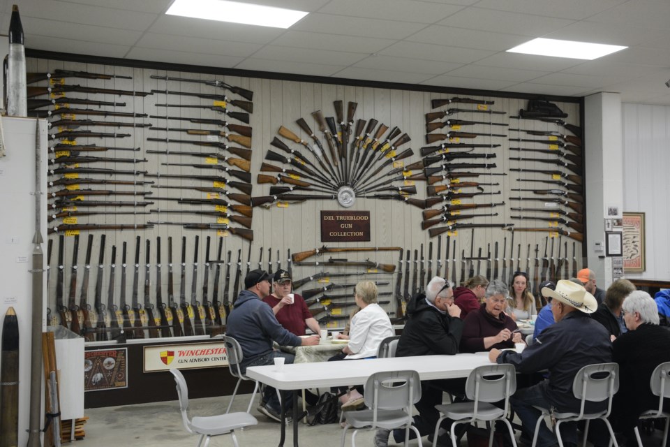 Part of the crowd enjoying breakfast at the Pioneer Museum on opening day, May 23. On the wall in the background is the large display of the Del Trueblood Gun Collection. 