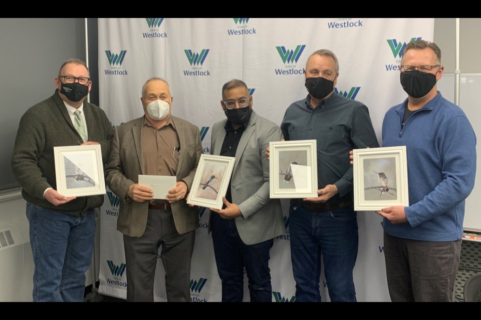 Former Town of Westlock councillors Clem Fagnan, David Truckey and John Shoemaker were lauded for their long service at the Dec. 13 council meeting — all three received locally produced artwork. L-R: Mayor Ralph Leriger, Fagnan, Coun. Murtaza Jamaly, Coun. Randy Wold and Coun. Curtis Snell.