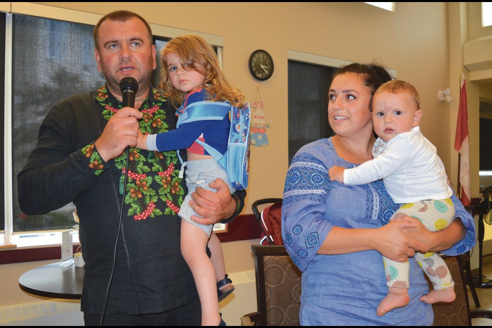 Yuriy and Lilia Vovk, and two of their three children, nine-month old Volodymyr and three-year old Victoria, share a few words and thank the community and residents of Smithfield and Pembina Lodge for their generous donations and support, since arriving from Ukraine May 20. 