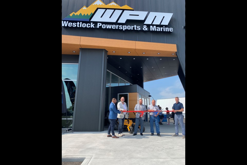 The new $7 million Westlock Powersports and Marine building officially opened Aug. 20 with a ribbon-cutting ceremony. Town of Westlock Coun. Murtaza Jamaly and mayor Ralph Leriger handled the left end of the ribbon, while Westlock and District Chamber of Commerce vice-president Paul Olsen manned the other end as WPM dealer principal Dan Horinek and his father Ehreth, who’s president of Precision Design and Manufacturing, did the honours.