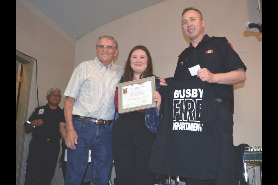 John Lessard, left, joined Busby fire chief Jared Stitsen to thank 16-year-old Annie Roy from St. Albert in a special ceremony May 28 for her life-saving actions April 23 at the Busby Jamboree. Stitsen presented Roy with a certificate of recognition and a Busby fire department t-shirt.   Photo Kristine Jean/Great West Media