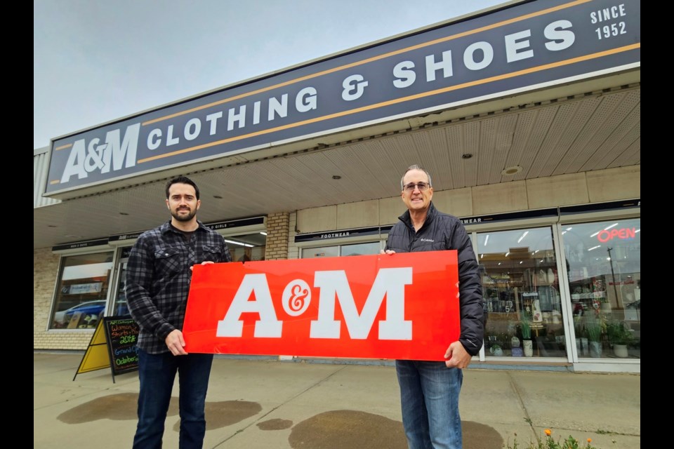 A&M Clothing & Shoes in Westlock is celebrating 71 years in business along with a rebranding to its original name from Arth’s Fashion Centre, as it has been known since 1985. To mark the milestone, the store is holding a grand opening Oct. 20 with sales, giveaways and draws and a ribbon cutting at 9:45 a.m. From L-R are: store manager Colton Arth and his father, store owner Todd, holding one of the original A&M storefront signs from decades ago.    