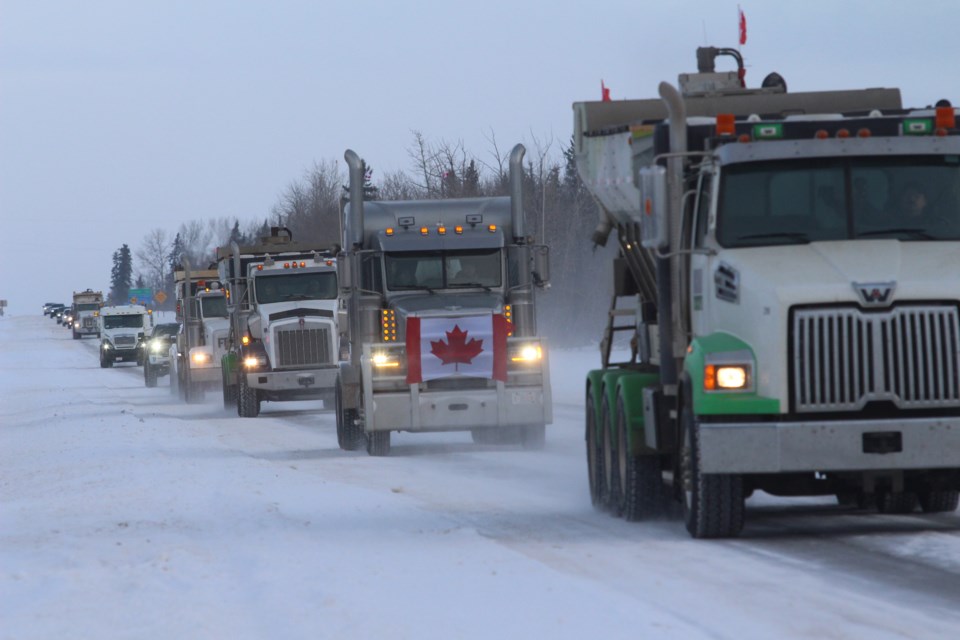 Residents around the region and
across the country continued
their protests against COVID
mandates and the federal government last weekend with different events in Athabasca, Barrhead, Boyle and Westlock Feb. 5. Pictured, a line of truckers and
other supporters as they leave
Westlock Saturday morning. 