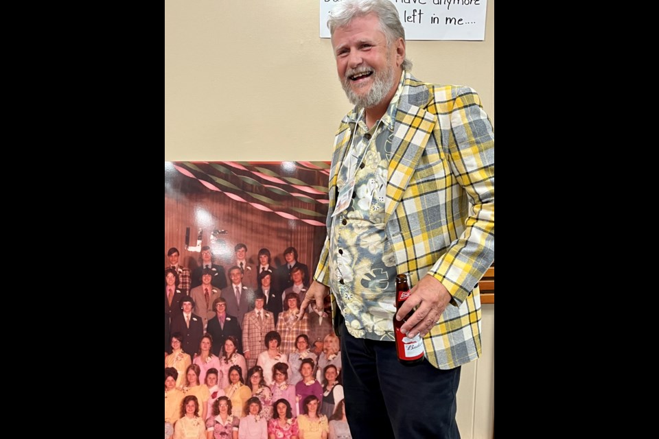 Members of the Class of 1973 from the Westlock High School gathered Aug. 25-26 to celebrate their 50-year reunion. Pictured is Doug Cross wearing his grad jacket pointing to himself in the giant grad photo.