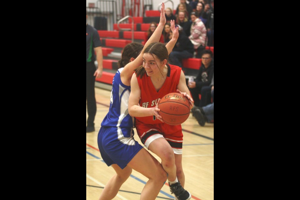 R.F. Staples School’s Emma Van Djik slips around a Parkland Composite High School defender during the T-Birds’ 52-44 win in Game 2 of their home tournament played Feb. 23-24. In the final, the T-Birds downed Grande Prairie’s Glenmary School Saints 42-41.