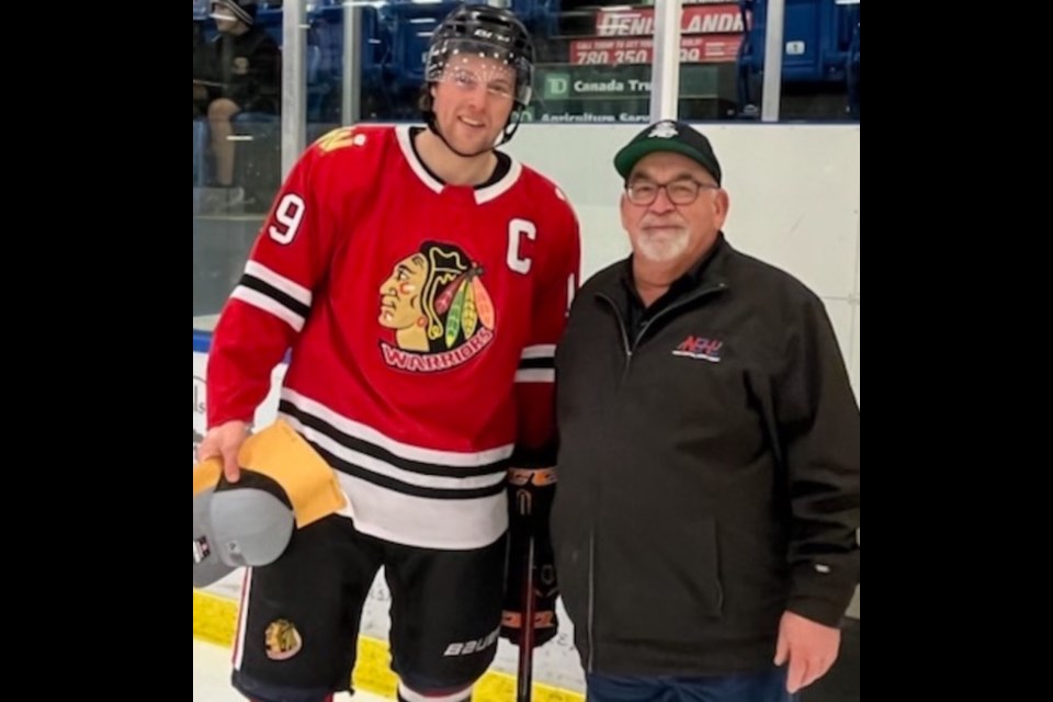 Warriors' captain and coach Mike Ivey was named the North Central Hockey League coach of the year during a short pre-game ceremony. Presenting the award to Ivey is NCHL president Jerry Muise.