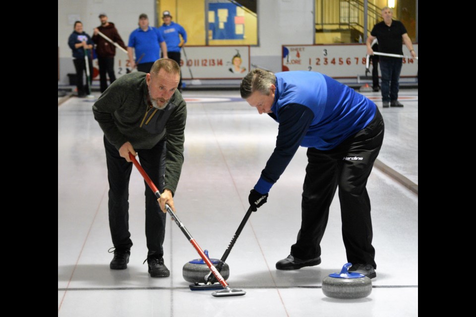 Dozens of area curlers came out for the Westlock Curling Club’s final bonspiel of the season, March 10-12, which was originally scheduled to be the men’s bonspiel and was changed to an open bonspiel format. Randy Musterer from Dapp and Sheldon Hay from Westlock stay focused as they sweep a rock down the ice March 10.  