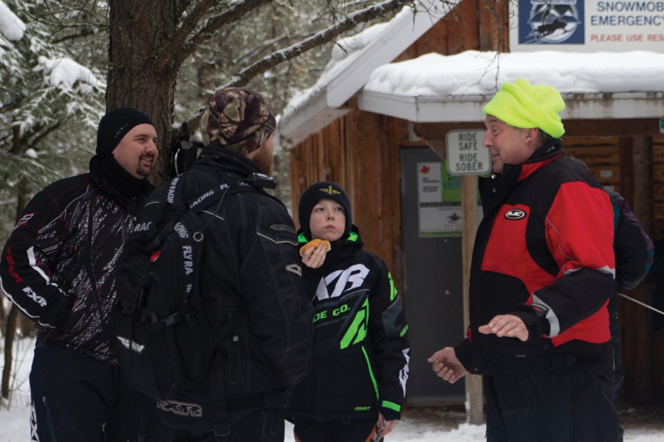 Cameron Clark, Geoff Hale, his son Tristan, and Laurier Boissonnault paused for a hot dog and a chat at the cabin on the trail during the Pembina Driftbusters Snowmobile Rally Feb. 1.
Photos by Andreea Resmerita/WN