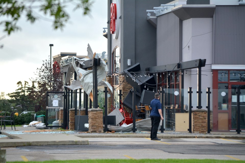 Boston Pizza owner Sheldon Hay surveys the damage to his restaurant after a severe thunderstorm with wind speeds between 80 to 100 km/h ripped through town in the early morning hours of July 25.
Photos by Les Dunford & Kristine Jean/WN