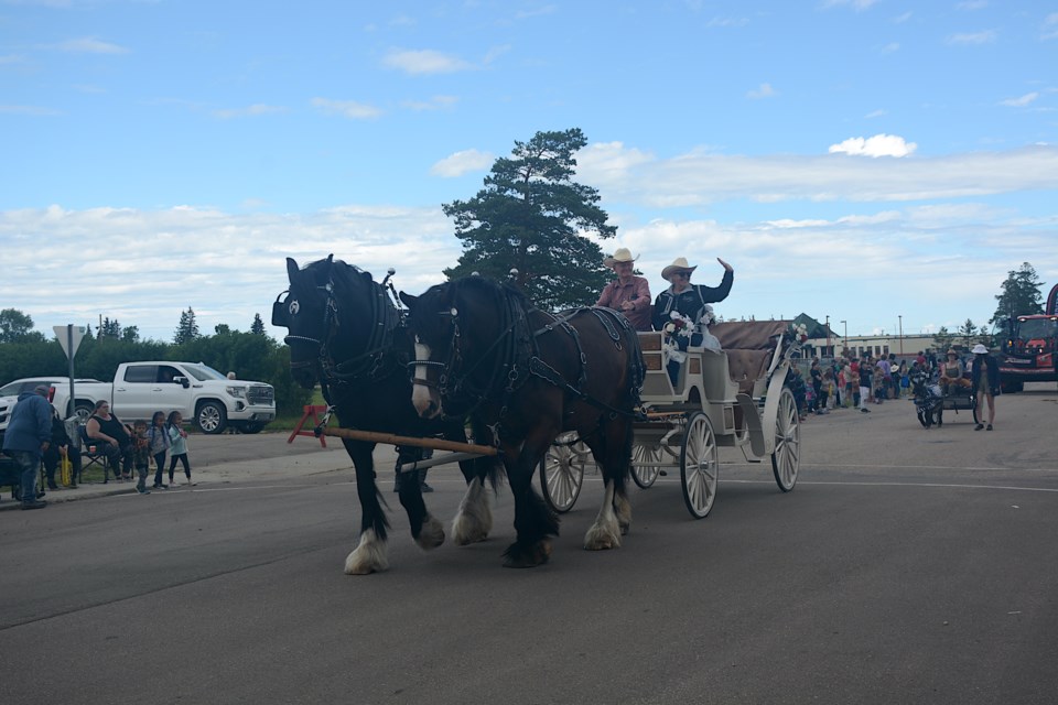 Mel and Doris Clack, who live east of Clyde, with their team of draft horses and beautiful carriage used in the June 17 parade. Later, using a flat-deck wagon with seating, they provided rides around the ag grounds. 