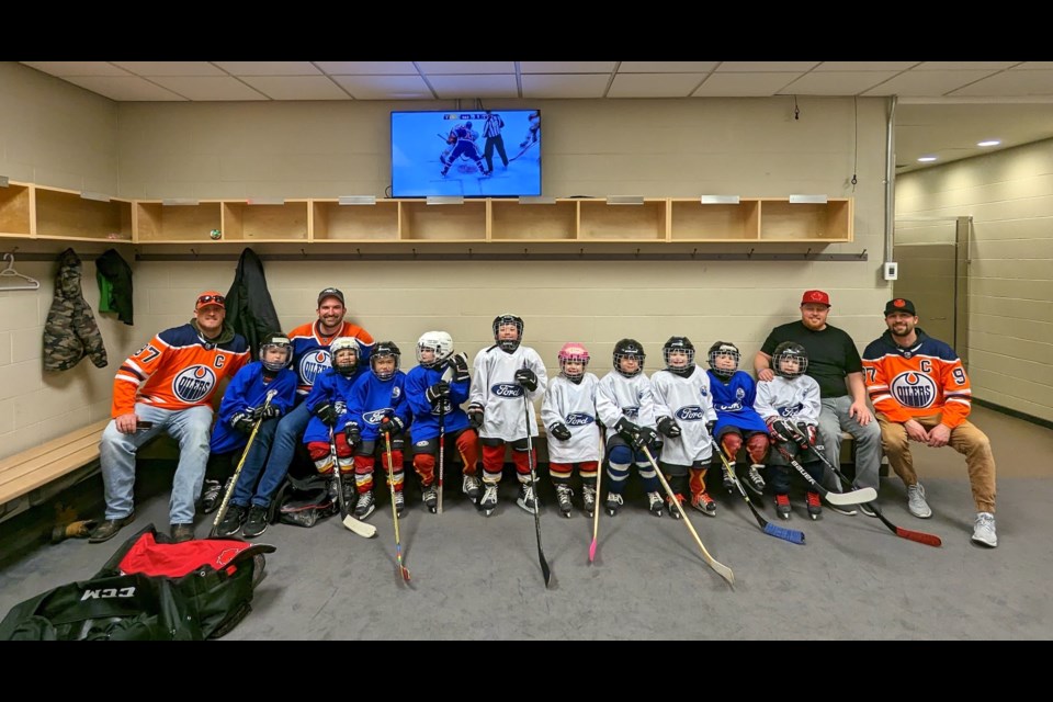 The Westlock U7-3 Warriors were all smiles before hitting the ice with the Ford Small Stars program during first intermission in a game between the Edmonton Oilers and Boston Bruins Feb. 27 at Rogers Centre. L-R: Laine Allen (coach), Jack Kiselyk, Shaun Kiselyk (coach), Ethan Laughy, Matthew Beaver, Lawson Landry, Ryder Zadunayksi, Ayda Properzi, Boone Allen, Cohen Weisgerber, Maddox Brand, Leo Montgomery, John Montgomery (coach) and Chris Brand (coach).