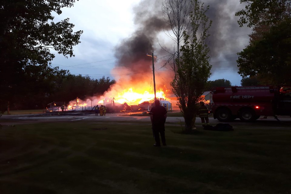 Residents captured the Jarvie General Store, which also housed the community post office, while it was burning early this morning. Submitted