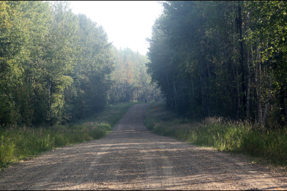 On Sept. 8, RCMP officers can be seen in the distance walking along the gravel road and checking ditches as they are searching for something. 