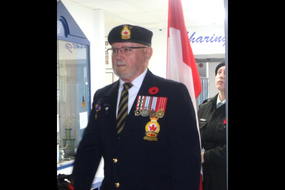 Westlock Legion #97 Vice-President Wayne Inkmen leads the carrying in of the colours during the Remembrance Day ceremony at St. Mary School in Westlock on Nov. 8. Westlock Mayor Jon Kramer also attended. 