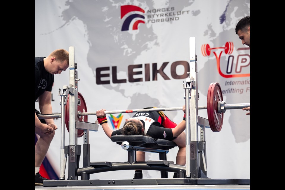 Mimi Frank gets in position for an attempt at the classic bench press while spotters prepare to catch the bar in case of failure. Frank benched 92.5 kilograms to earn the gold medal and keep the title of world champ for the second year running. 