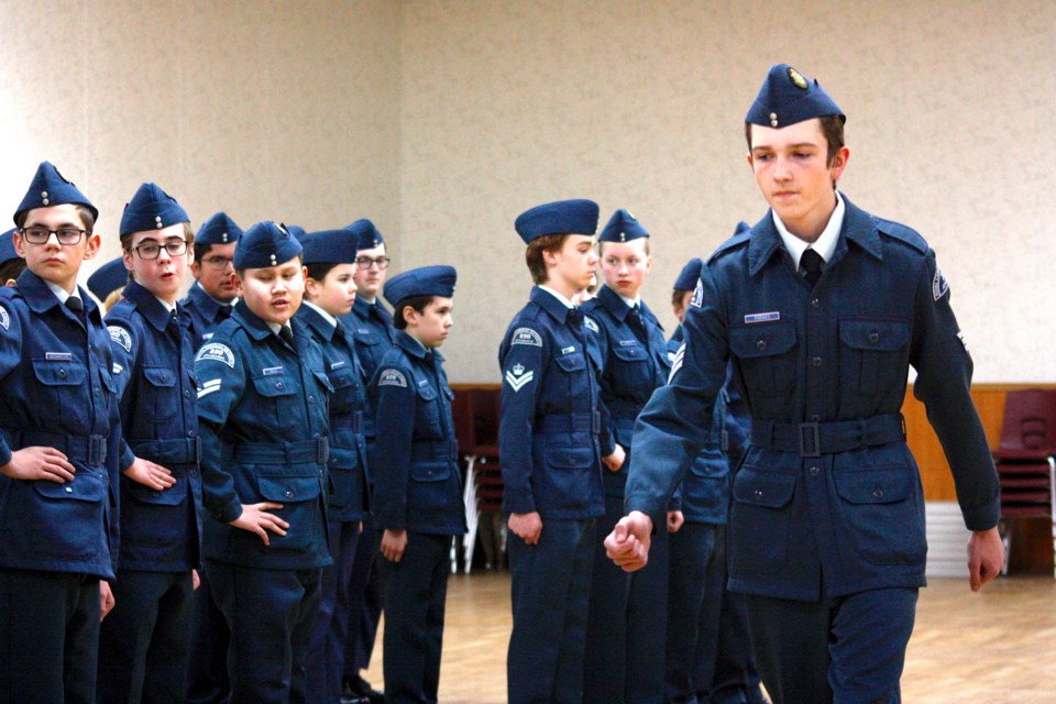 Deputy Flight Commander Xander Paradis hands off the Lancaster flight during the commanding officers parade Dec.7, as the club celebrated its 80th anniversary. 