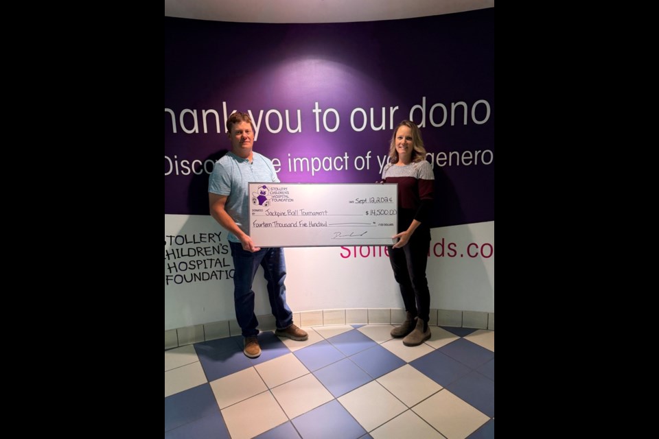 The Woods present the cheque from their Jack Pines ball tournament to the Stollery Children's hospital on Sept 12 for $14,500. Photo supplied by Jen Wood