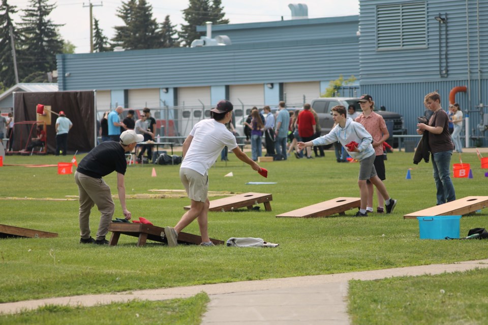 Students (L-R) William Quist, Jackson Rea and Brolyn Boissonnault enjoy a game of corn hole.