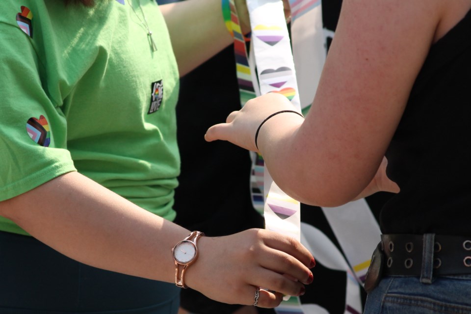 Students picking their pride flag sticker. 