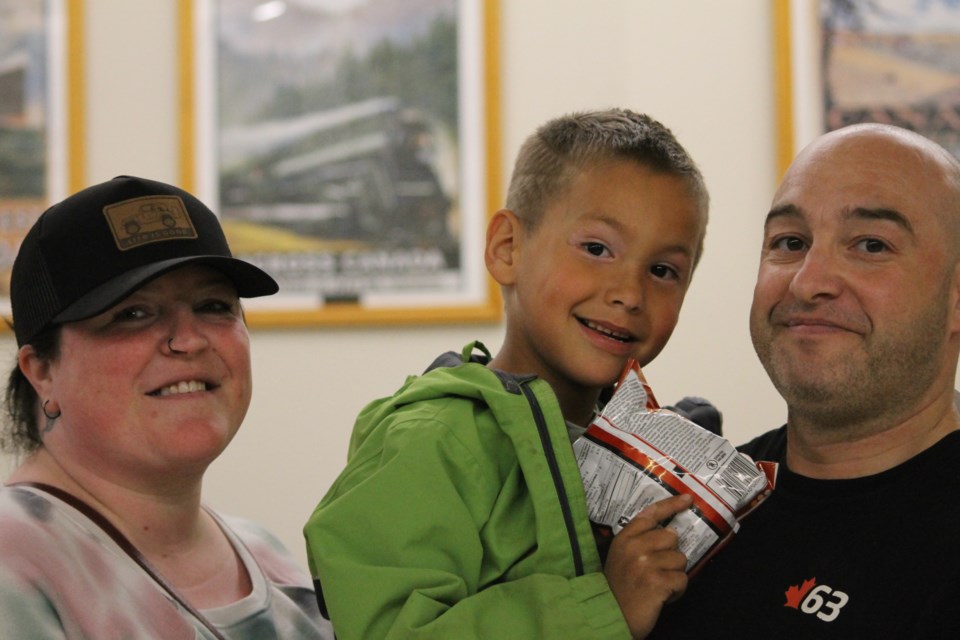 Tracy Beauséjour (left) with Marcus Kerr (right) and his son Nathan (centre) pose for a photo before heading to the outdoor activities. 