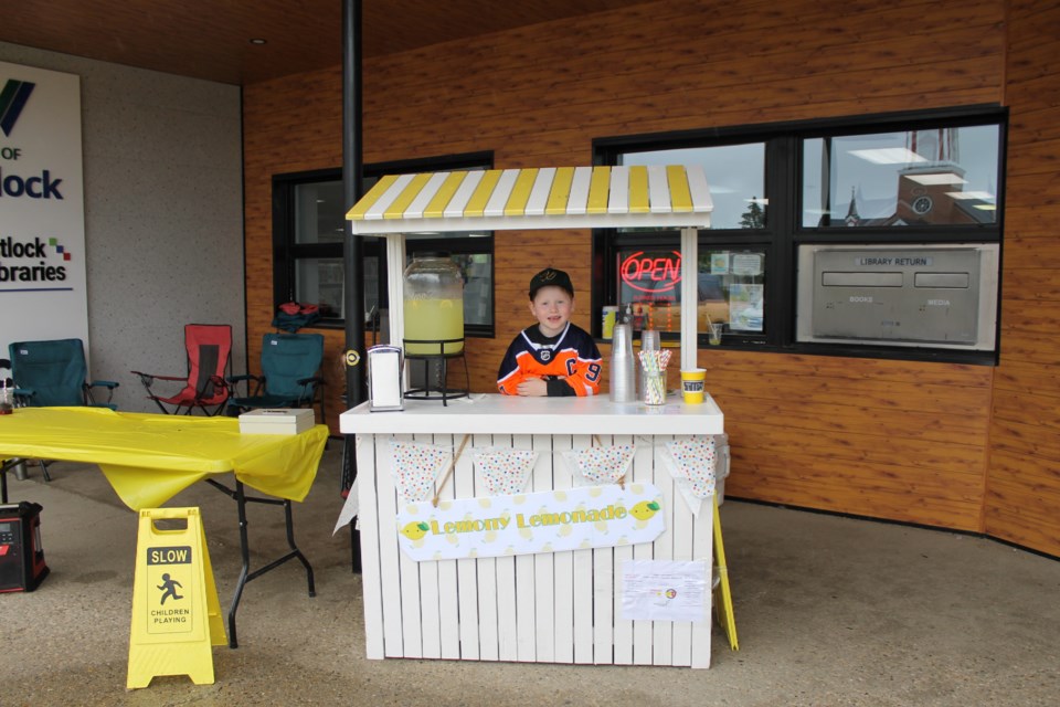 Westlock entrepreneur (and lemonade enthusiast) James Rhoad selling Lemonade in front of the Westlock Library. 