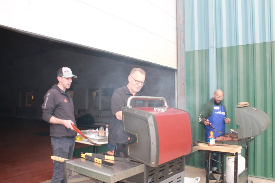 Mayor Kramer (left), Councillor Snell (centre) and Councillor Jamaly (right) working the grill. 