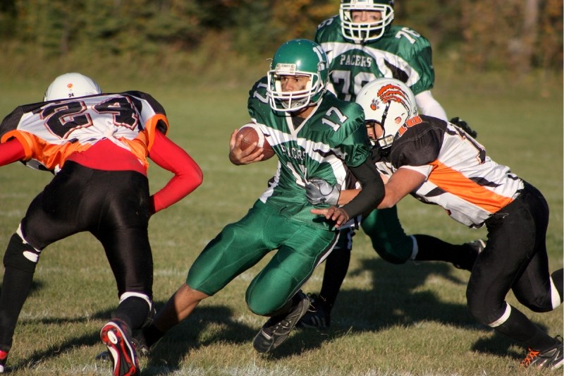 EPC Pacer quarterback Gaetano Minto (m) is mauled by several St. Paul Lions during the second quarter of action in Friday night&#8217;s match-up at Edwin Parr Composite