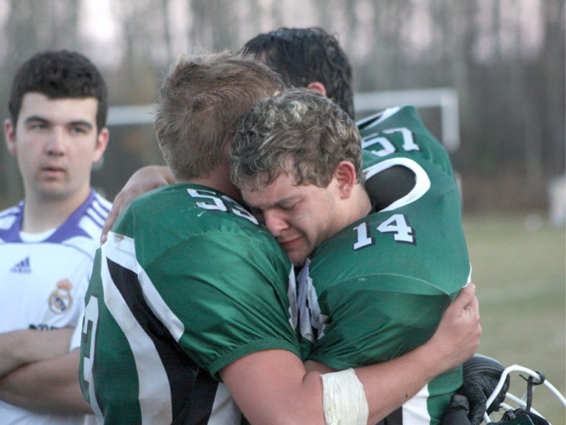 EPC Grade 12 Pacers Mat Smith (l) and Tyler Wildfong embrace after a loss in their last home game of their high school football careers.