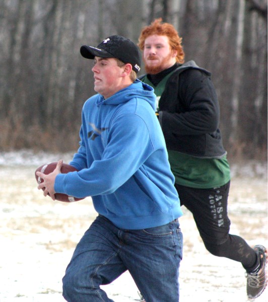 Former EPC Pacer Mat Smith (front) runs away from Travis Koster in a pick-up game of touch football at the Pacers wrap-up party last Wednesday evening at EPC school.